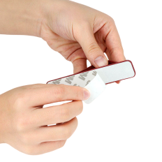 Self-adhesive phone holder on finger with gray zipper